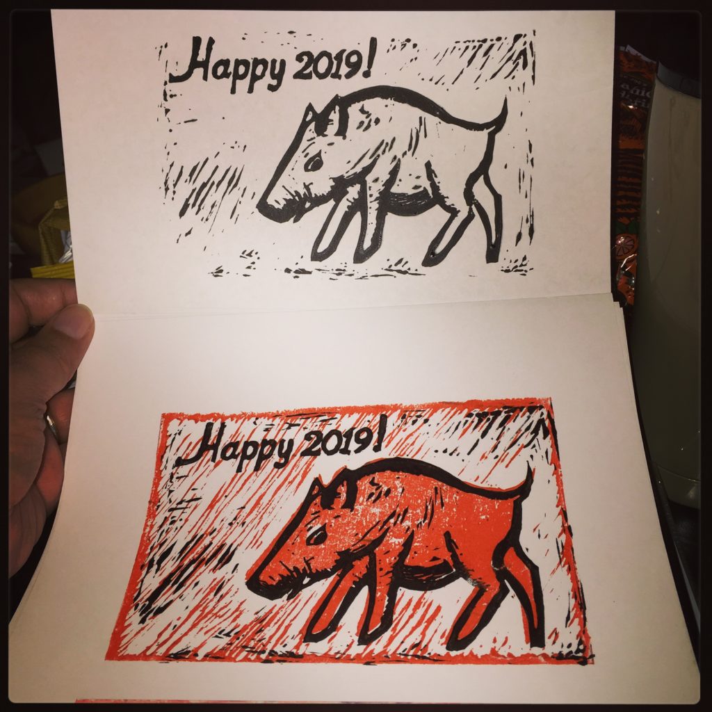 Eraser carving (postcard-sized eraser) of a boar for 2019 in two colors (red and black).